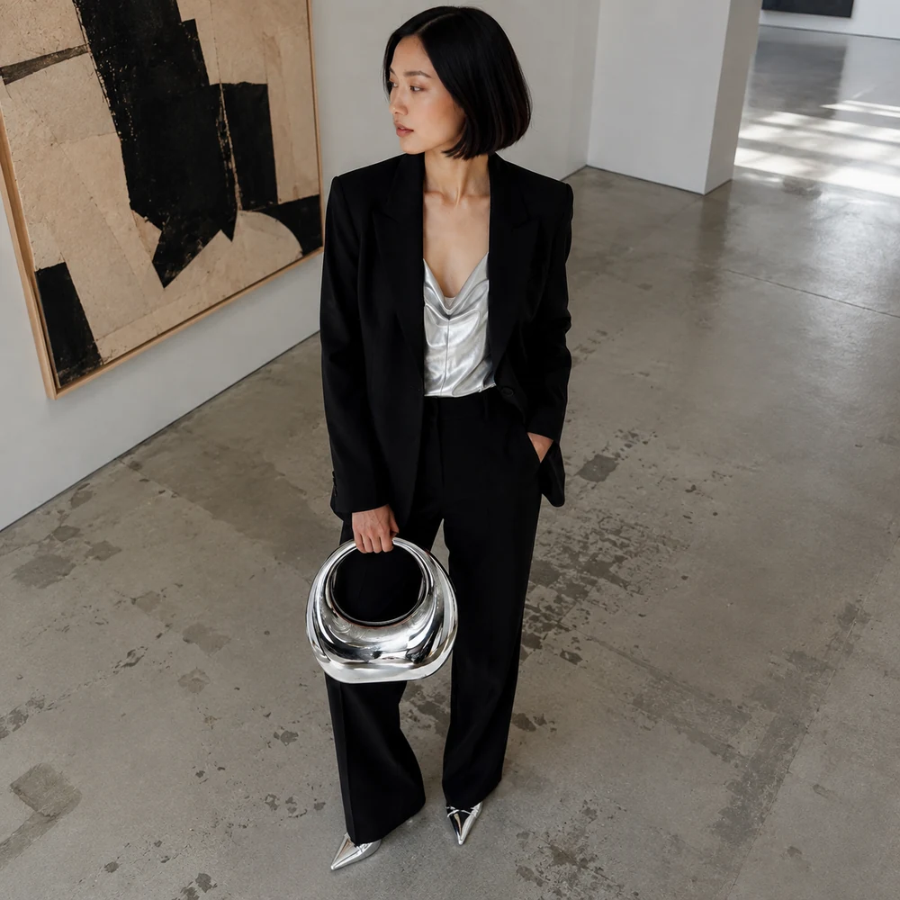 girls-night-out-silver-acrylic-handbag-high-angle-05 Silver-tone acrylic ring handle evening handbag carried with a black suit