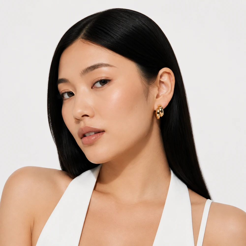gleam-on-gold-sculptural-double-band-mini-hoop-earrings-model-portrait-02 Wholesale Gold-Tone Double-Band Hoop Earrings - main view