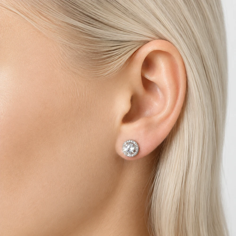 gonna-be-different-medium-silver-halo-crystal-stud-model-closeup-04 Silver-tone circular halo rhinestone stud earring shown at the ear