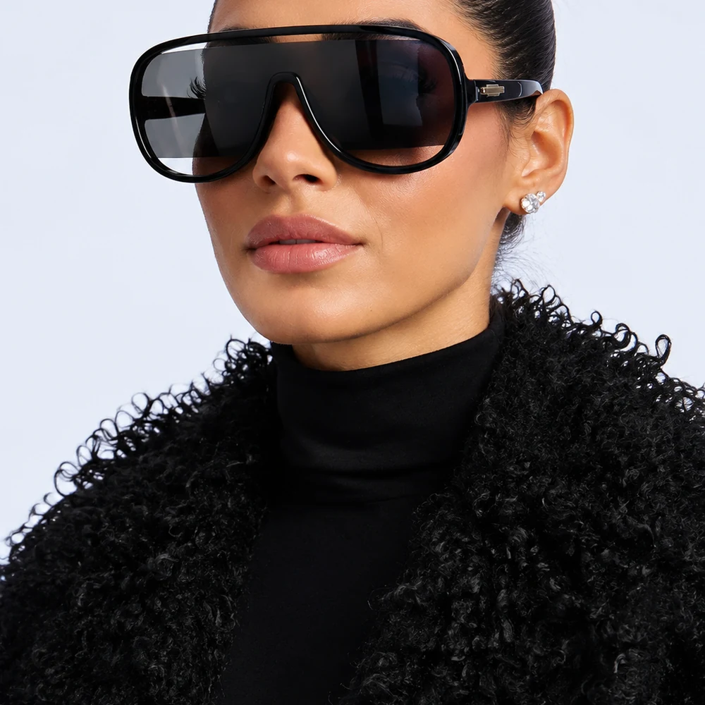 keep-them-off-black-shield-aviator-sunglasses-front-01 Black shield aviator sunglasses with central cut-out bridge worn on a model