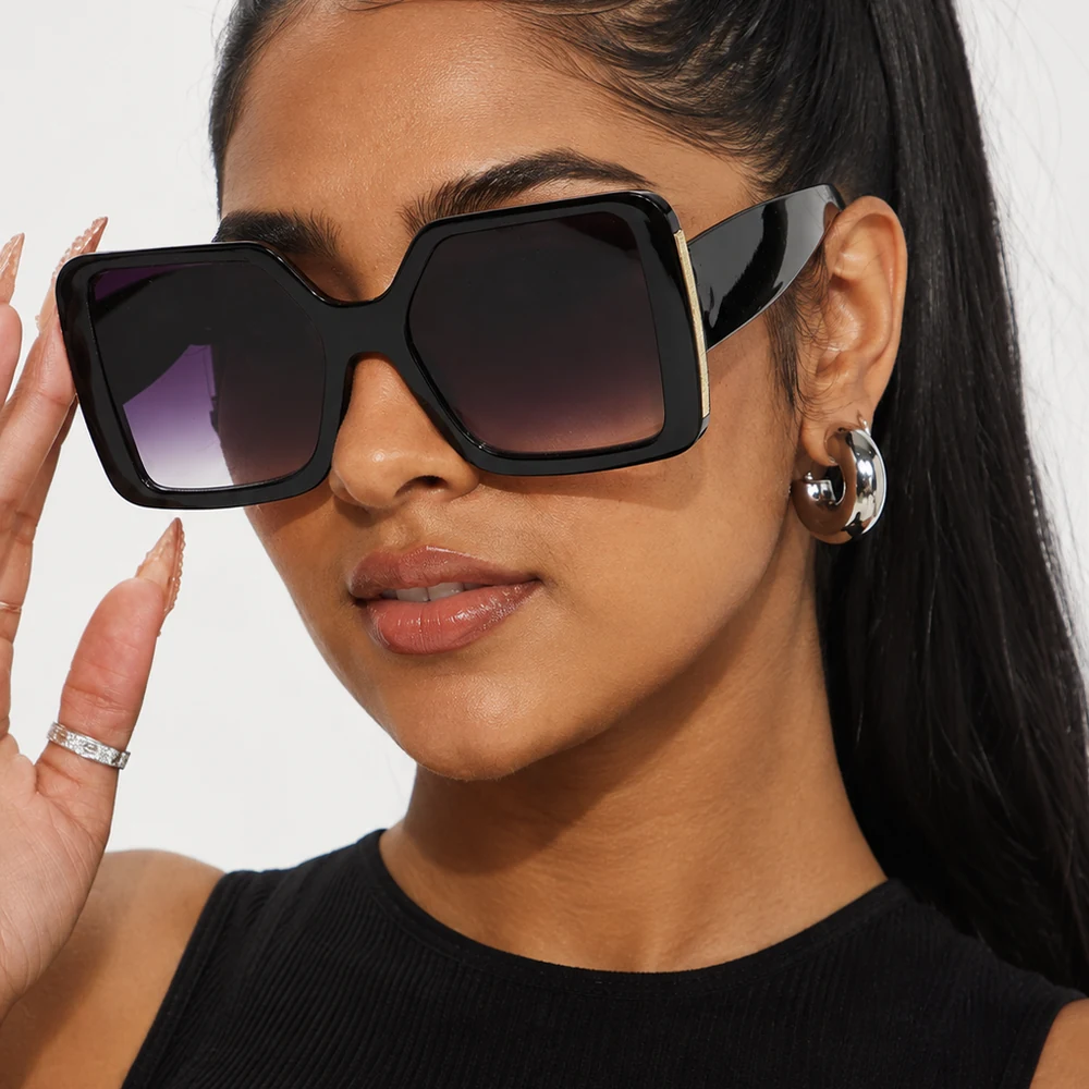 never-letting-go-black-oversized-square-sunglasses-worn-01 Black oversized square sunglasses with textured metal temple detail worn on a model