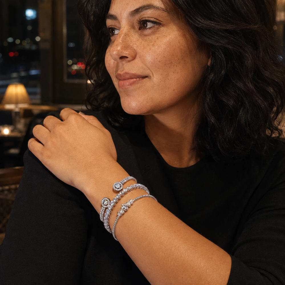 night-out-silver-rhinestone-open-cuff-bracelet-set-restaurant-lifestyle-01 Three silver-tone rhinestone bracelets worn together with a black top