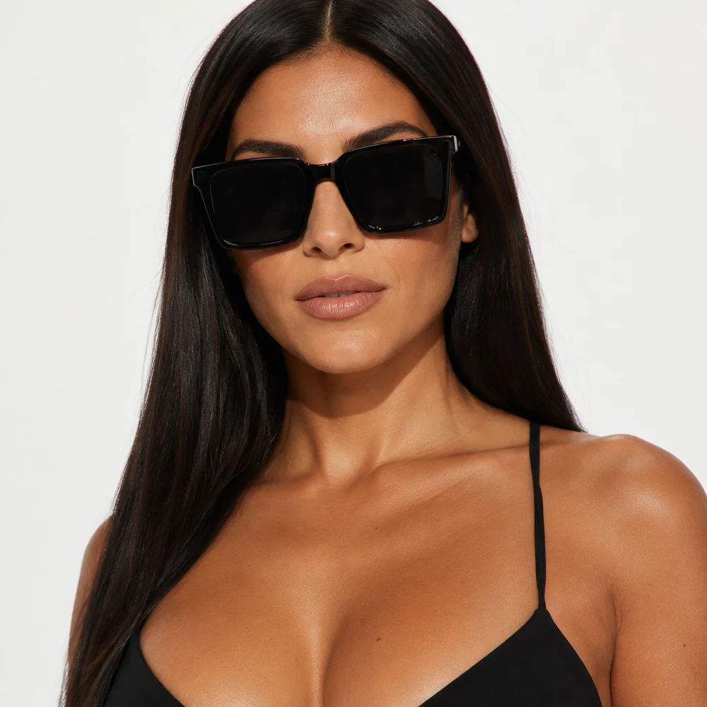 shades-on-black-oversized-square-sunglasses-front-01 Black oversized square sunglasses with translucent frame detail, front model portrait